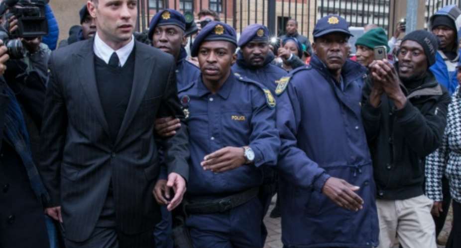 South African Paralympian Oscar Pistorius leaves the high court in Pretoria.  By Marco Longari AFP