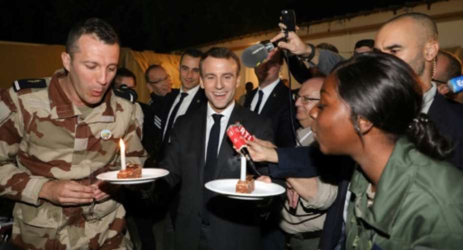 Last year French President Emmanuel Macron celebrated with French troops in Chad.  By Ludovic MARIN AFP