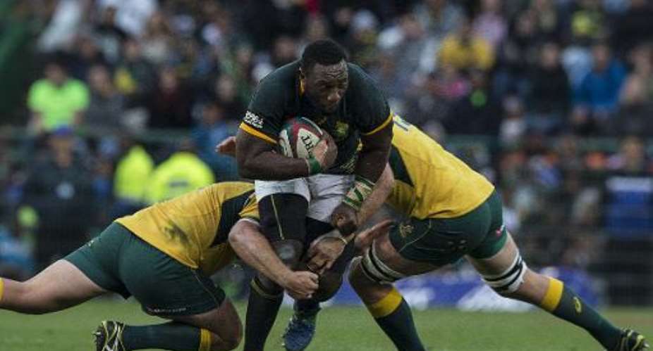 South African prop Tendai Mtwarira C is tackled during the Four Nations tournament rugby union match between South Africa and Australia at the Newlands stadium on September 27, 2014 in Cape Town.  By Marco Longari AFP