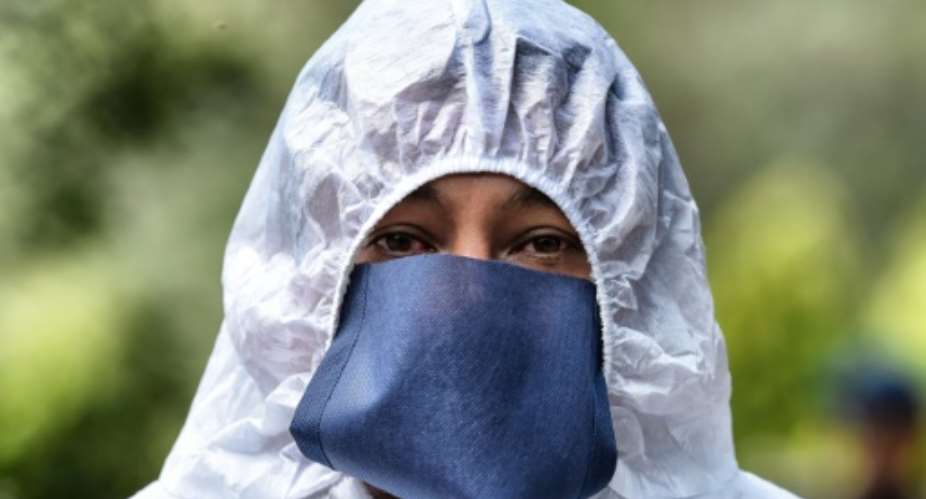 Latin America has now suffered at least 70,000 dead from the coronavirus outbreak and in Mexico funeral workers wear full protective equipment.  By ALFREDO ESTRELLA AFP