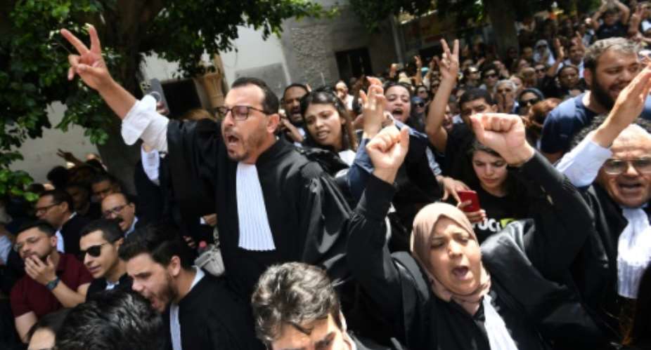 Lawyers chant anti-Saied slogans outside the main courthouse in Tunis.  By FETHI BELAID (AFP)