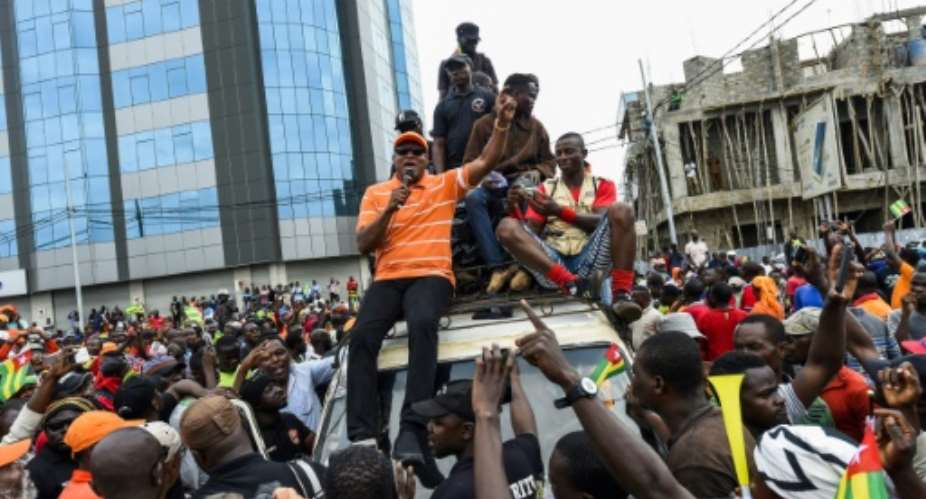 Leader of opposition Jean-Pierre Fabre C sits on a truck to address supporters during an anti-government protest in Lome, on September 7, 2017.  By PIUS UTOMI EKPEI AFP