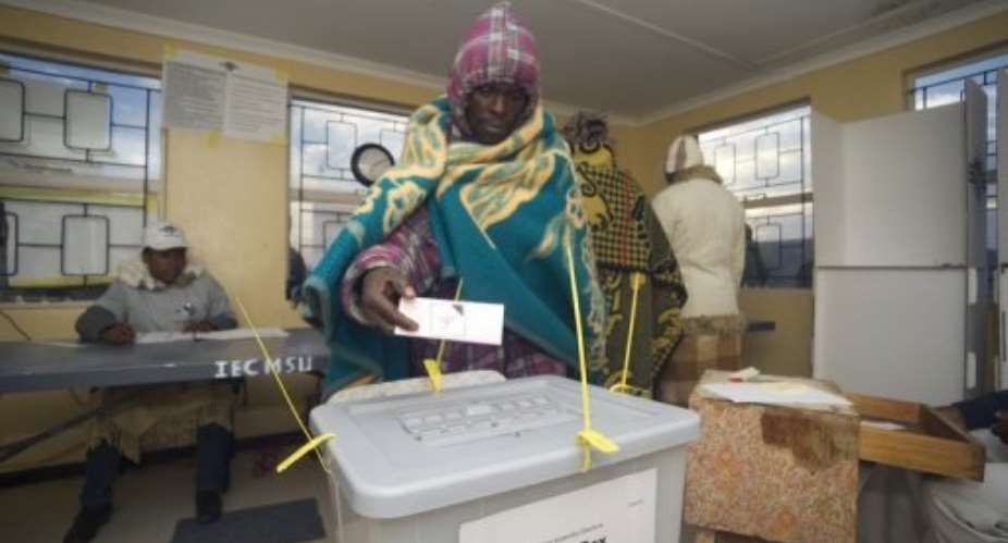 A Basotho man casts his vote at a polling station some 20kms outside Maseru.  By Alexander Joe AFP