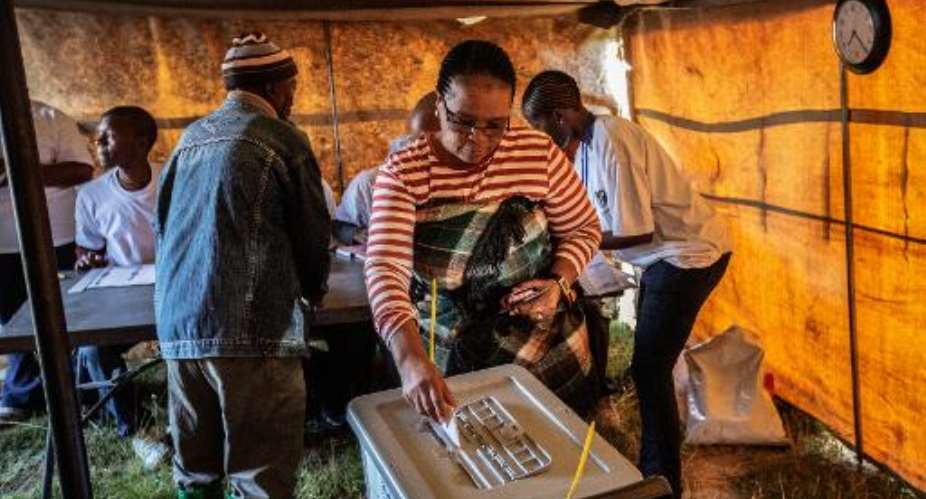 A resident casts her ballot for the parliamentary elections at a voting station on the outskirts of Lesotho's capital Maseru on February 28, 2015.  By Gianluigi Guercia AFP