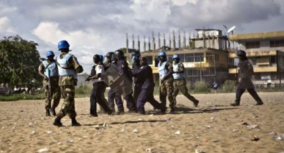 Liberian police officers and UN peacekeepers makes arrests during a riot in Monrovia in November 2011.  By Glenna Gordon AFPFile