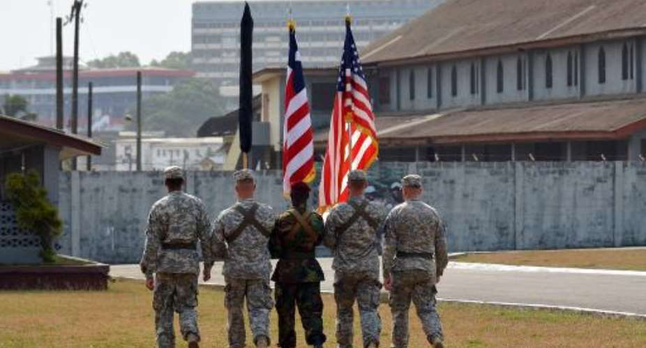 US soldiers of the 101st Airborne Division case their colours during a ceremony at the Barclay Training Camp in Monrovia on February 26, 2015.  By Zoom Dosso AFP