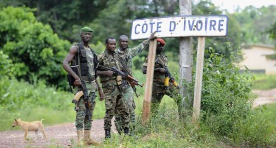 Ivory Coast militiamen pose at the border with Liberia in 2011.  By Philippe Desmazes AFPFile