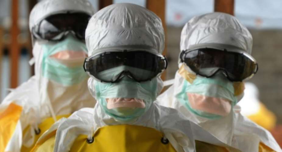 Health care workers, wearing protective suits, leave a high-risk area at the French NGO Medecins Sans Frontieres Elwa hospital in Monrovia on August 30, 2014.  By Dominique Faget AFPFile