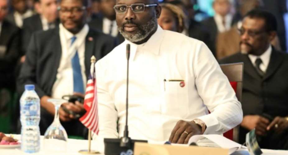 Liberian President George Weah is under growing pressure from the opposition over his handling of the country's economic crisis.  By Kola SULAIMON AFP
