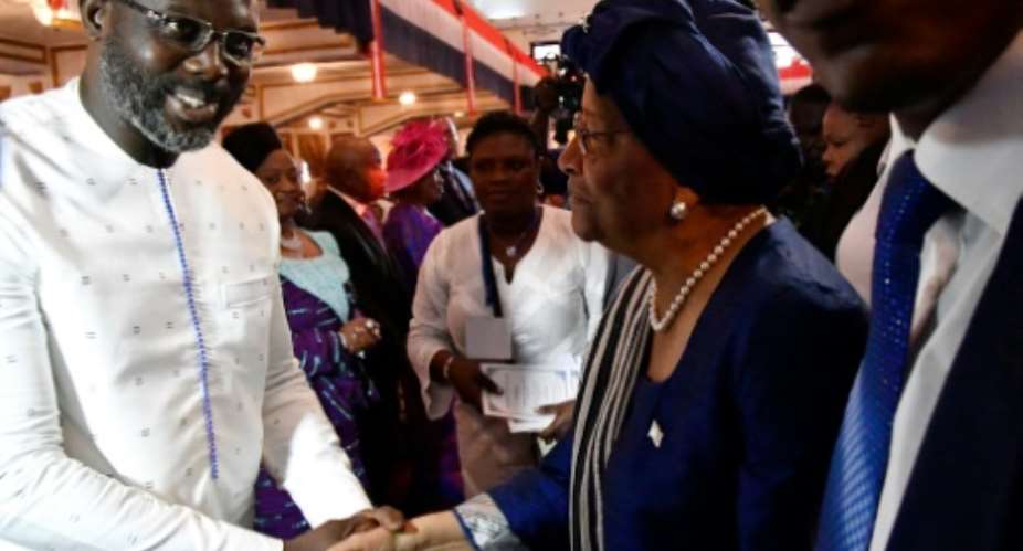 Liberia's president-elect and former football star George Weah attended a church service with the country's outgoing president Ellen Johnson Sirleaf at the centennial memorial pavilion in Monrovia on Sunday.  By ISSOUF SANOGO AFPFile