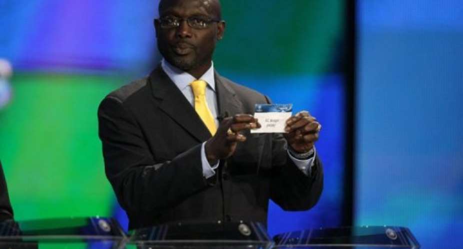 Former player George Weah proceeds to the draw for the UEFA Champions League group stage 201213, in August 2012.  By Valery Hache AFPFile