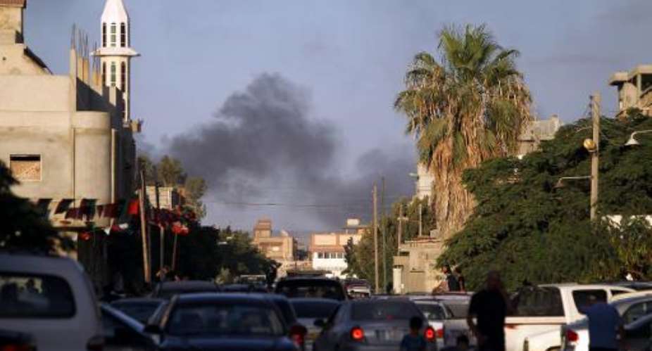 Smoke billows during clashes between Libyan security forces and armed groups on July 23, 2014, in the eastern city of Benghazi.  By Abdullah Doma AFP