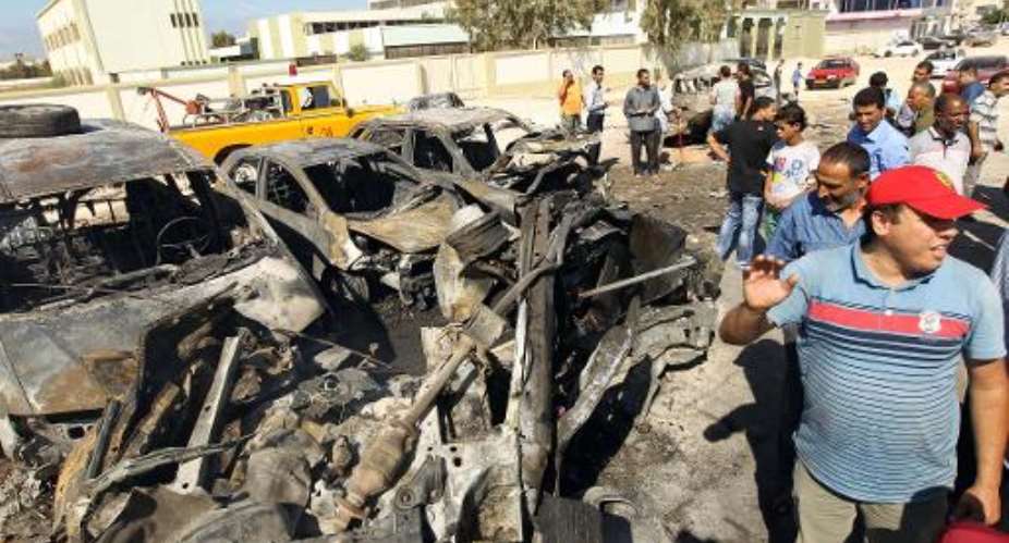 Benghazi residents gather at the site of a car blast on October 26, 2013.  By Abdullah Doma (AFP/File)