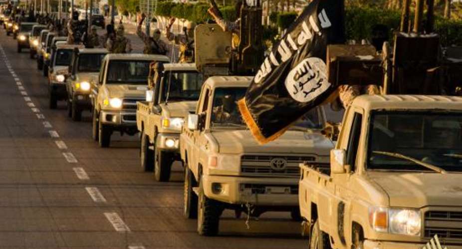 Islamic State IS militants are purportedly seen parading in a street in Libya's coastal city of Sirte, in an image released by propaganda Islamist media outlet Welayat Tarablos on February 18, 2015.  By  Welayat TarablosAFPFile