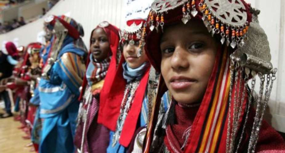 Libyan girls wear traditional outfits during celebrations to mark the first anniversary of the countrys liberation.  By Abdullah Doma (AFP)