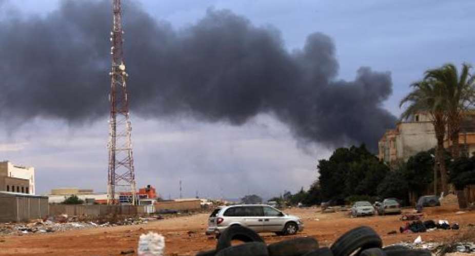 Smoke billows from buildings in Benghazi pounded by Libyan airforce, as they were reported storing ammunition belonging to Benghazi-based Islamist Ansar al-Sharia group, on October 22, 2014.  By Abdullah Doma AFPFile