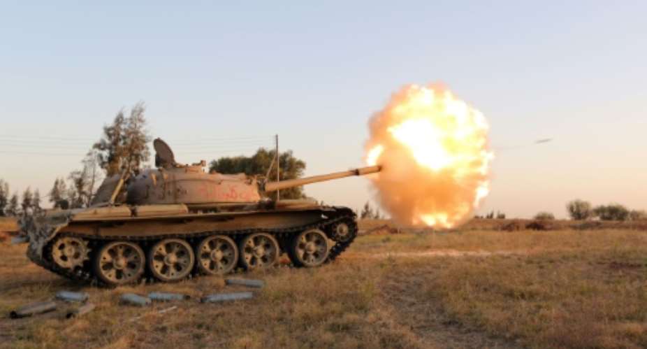 Fighters from the Fajr Libya militia fire shells from a tank during clashes with forces loyal to Libya's internationally recognised government, southwest of Sabratha on April 28, 2015.  By Mahmud Turkia AFPFile