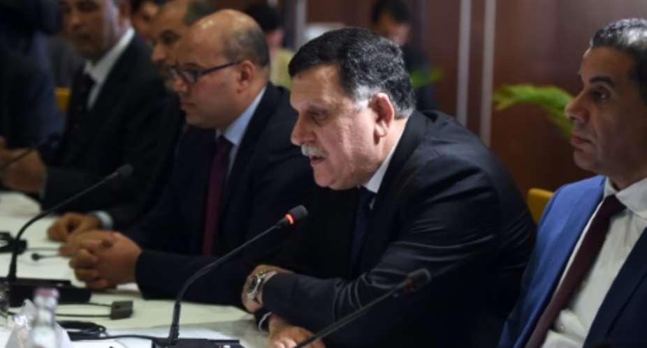 Libyan Prime Minister Fayez al-Sarraj 2nd R said the presence of foreign ground troops to fight the Islamic State group would be contrary to our principles.  By Fethi Belaid AFPFile