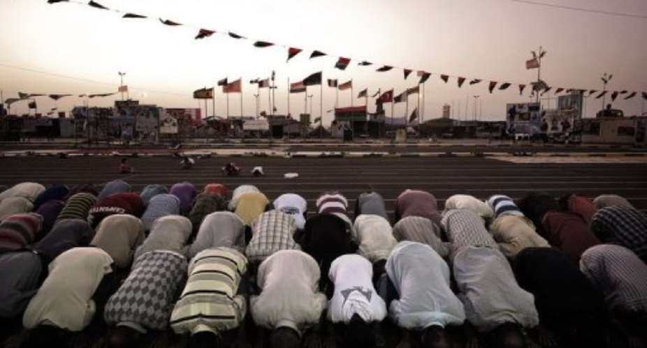 Libyan men at prayer in Benghazi after the first fasting day of Islams holy month of Ramadanon Monday.  By Gianluigi Guercia (AFP/File)