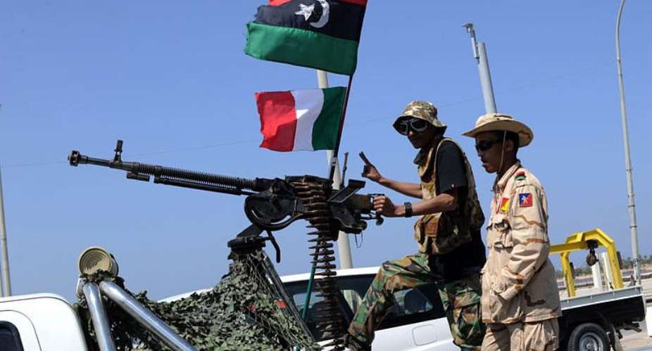 Libyan rebel fighters secure the premises of a hotel in Benghazi.  By Saeed Khan (AFP)