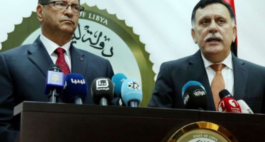 Tunisian Prime Minister Habib Essid L and Libyan Prime Minister of the UN-backed unity government Fayez al-Sarraj R give a joint press conference on May 6, 2016, at a naval base in the Libyan capital Tripoli.  By Mahmud Turkia AFP