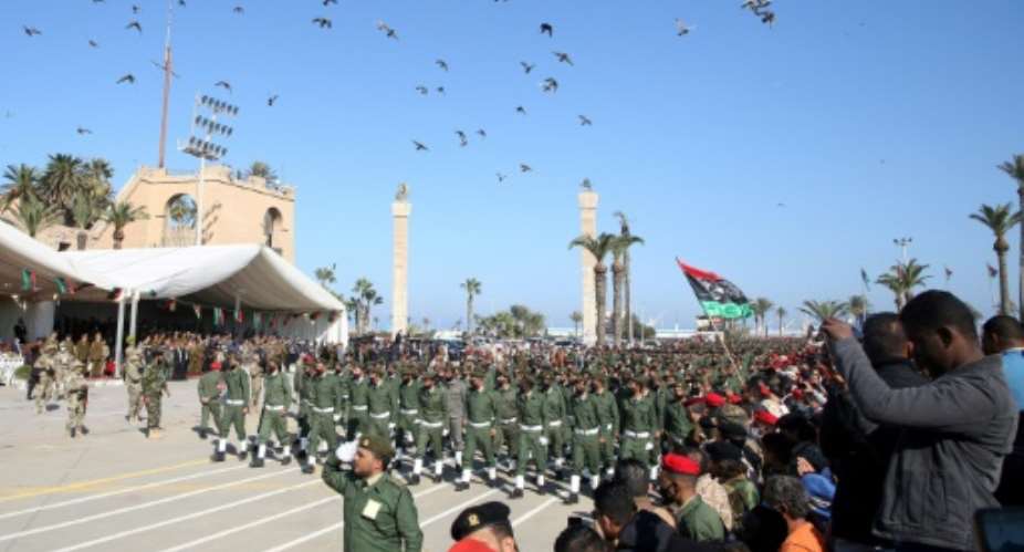 Libyan armed forces parade through the capital Tripoli to mark the country's 69th anniversary of independence.  By Mahmud TURKIA AFP