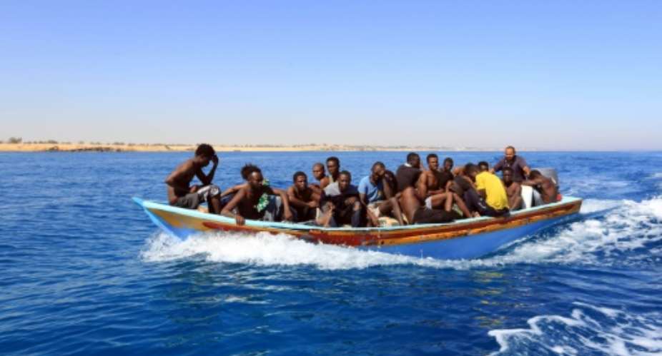 Libyan coastguards help rescue illegal immigrants attempting to reach Europe off the coastal town of Guarabouli, 60 kilometres east of the capital, on July 8, 2017.  By MAHMUD TURKIA AFPFile