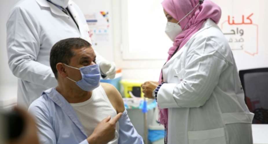 Libyan Prime Minister Abdelhamid Dbeibah receives his vaccination  against coronavirus.  By Mahmud TURKIA AFP