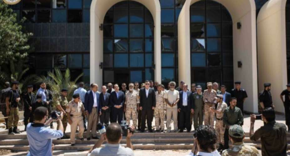 Libyan Prime Minister Fayez al-Sarraj C posing with forces of the UN-backed Government of National Accord GNA during his visit in the eastern coastal city of Sirte.  By HO Libya's Prime Minister Facebook PageAFP