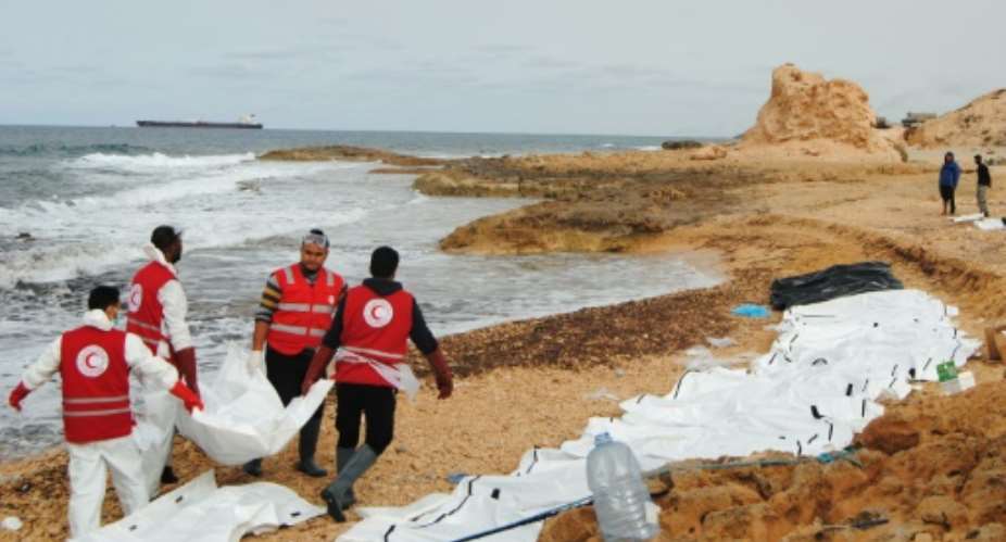 Libyan Red Crescent volunteers recovering the bodies of 74 migrants that washed ashore on February 20 near Zawiyah on Libyas northern coast on February 21, 2017.  By Mohaned KREMA Al-Zawiyah Branch - Libyan Red CrescentAFP