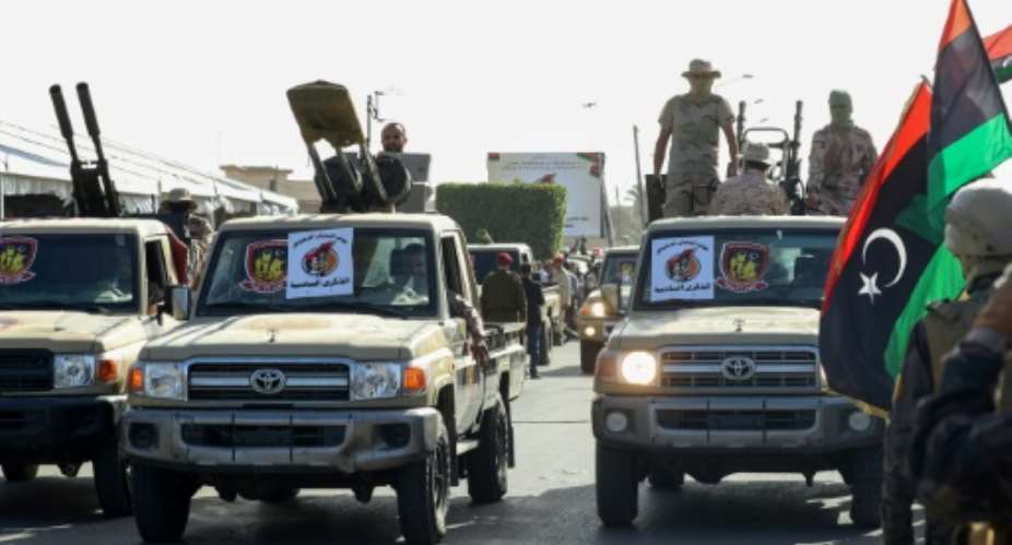 Libyan security forces affiliated with Tripoli-based interim Prime Minister Abdelhamid Dbeibah take part in a parade marking the 6th anniversary of the liberation of Sirte from Islamic State IS group on December 17.  By Mahmud Turkia AFP