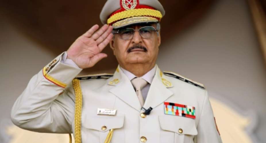 Libyan strongman Khalifa Haftar salutes during a military parade in the eastern city of Bengahzi on May 7, 2018, during which he announced a military offensive to take from terrorists the city of Derna.  By Abdullah DOMA AFP