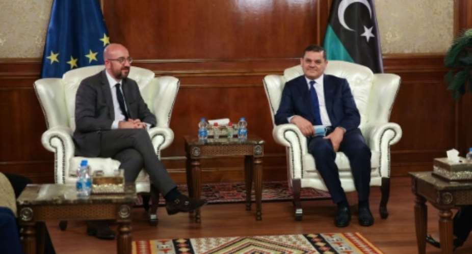 Libya's interim Prime Minister Abdul Hamid Dbeibah R meets with European Council President Charles Michel on Sunday.  By - AFP