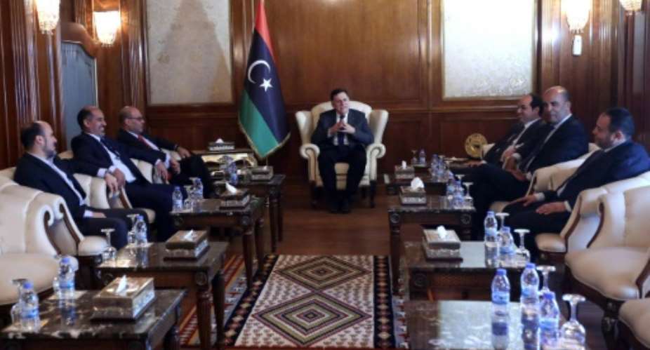 Libya's UN-backed prime minister-designate Fayez al-Sarraj C chairs a meeting of his Government of National Accord GNA on July 11, 2016, held for the first at the official government headquarters in the capital Tripoli.  By Mahmud Turkia AFP