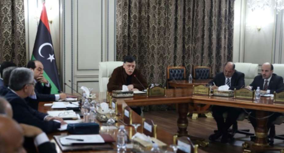 Libya's UN-recognised Prime Minister Fayez al-Sarraj C presided over a cabinet meeting where the implementation of a military deal with Turkey was 'unanimously approved'.  By - AFP