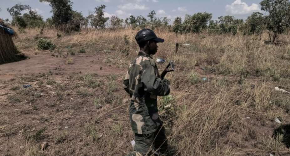 Local militiamen say they are paid to guard an artisanal gold mine in the southeastern DR Congo.  By Camille Laffont (AFP)