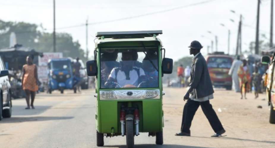 Local politicians are putting great faith in Chinese-made tricycle taxis with rechargable solar energy panels which have been plying routes in Jacqueville, a coastal town outside Abidjan.  By SIA KAMBOU AFP