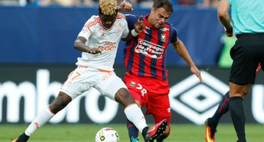 Lorient's Gabonese midfielder Didier Ndong L is tackled by Caen defender Damien Da Silva during a French Ligue 1 match in Caen, northwestern France on August 13, 2016.  By Charly Triballeau AFPFile