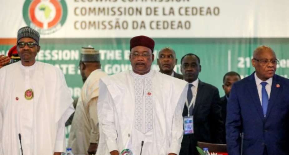 L-R: Nigeria President Muhammadu Buhari, Chairman, ECOWAS, Mahamadou Issoufou, and President of Ecowas Commission, Jean-Claude Kassi Brou attend the fifty-sixth ordinary session of the Economic Community of West African States in Abuja.  By Kola SULAIMON AFP