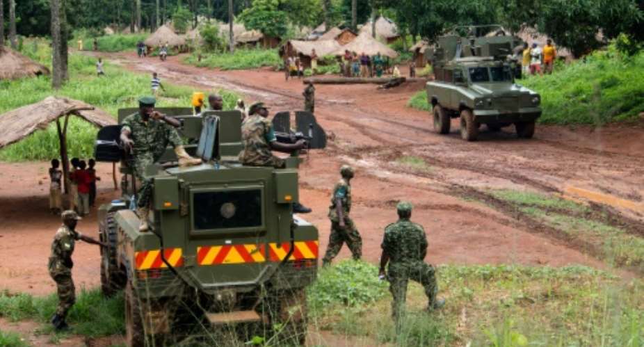 Soldiers of the Uganda People's Defence Force UPDF patrol in the northerneastern part of the Central African Republic to secure the area from rebel groups' possible attacks, on June 25, 2014.  By Michele Sibil Oni AFPFile