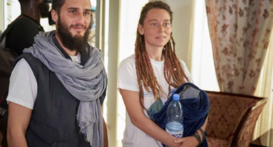 Luca Tacchetto and Edith Blais appeared slightly disoriented when they landed in Bamako.  By MICHELE CATTANI AFP