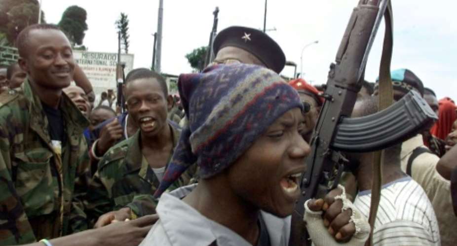 LURD rebels are seen in August 2003 near a Monrovia suburb.  By GEORGES GOBET AFPFile