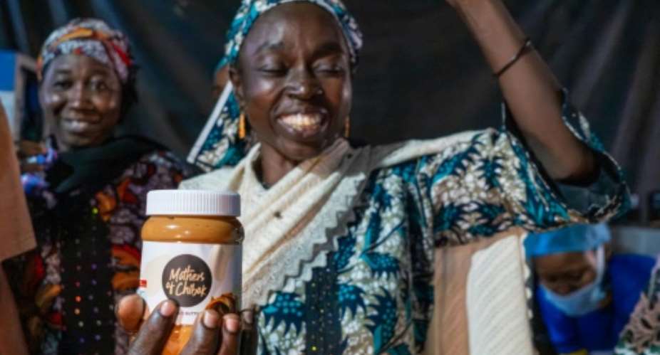 Lydia Yama, 47, is among the Nigerian women whose daughters were abducted in Chibok in 2014 and are now processing peanuts they cultivate at home into peanut butter and products.  By TOYIN ADEDOKUN (AFP)