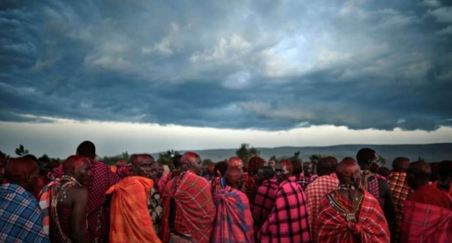 Maasai men gather to observe a traditional rite of passage last year at the Masai-Mara National Reserve.  By TONY KARUMBA AFP