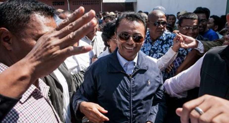 Marc Ravalomanana centre, former president of Madagascar who was in exile in South Africa since 2009, is greeted by supporters while returning to his home in Antananarivo on October 13, 2014.  By Rijasolo AFP