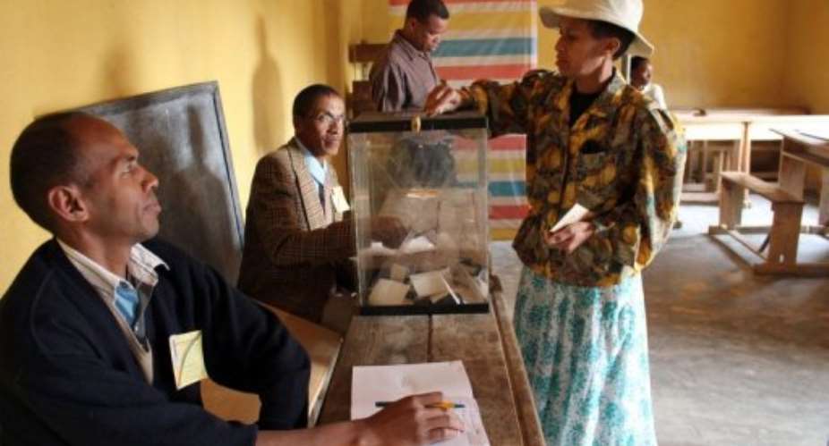 A resident of the Madagascars capital, Antananarivo, casts her vote at a local polling station on November 17, 2010.  By Gregoire Pourtier (AFP/File)