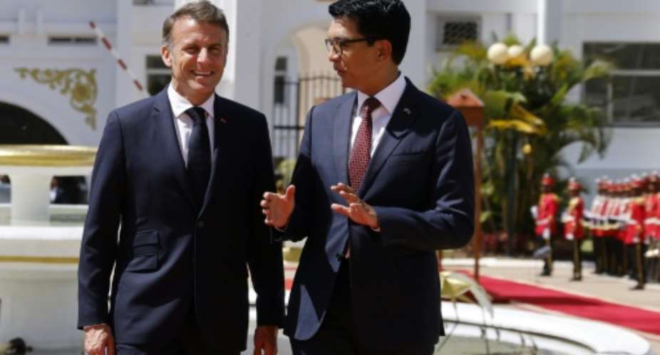 Madagascar President Andry Rajoelina (R) welcomed French President Emmanuel Macron for a two-day visit.  By Ludovic MARIN (POOL/AFP)