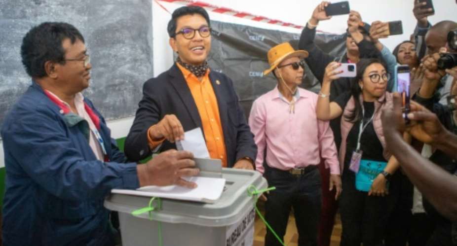 Madagascar's outgoing President Andry Rajoelina 2nd L urged people to vote and ignore an opposition call to boycott the polls.  By MAMYRAEL AFP