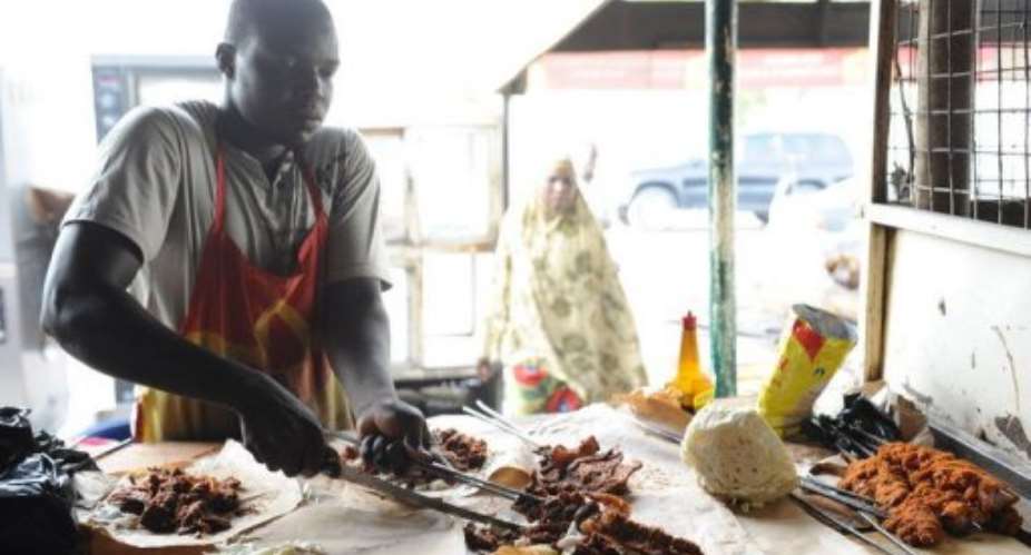 A vendor cuts suya in Maiduguri where, despite the threat of violence from Islamist rebels, barbecue shacks still thrive.  By Pius Utomi Ekpei AFPFile