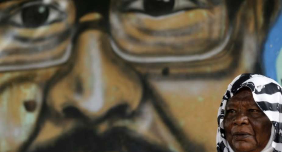 Maiyssa Omar says the painting of her son Walid Abdelrahim who was shot dead during protests last month keeps him alive.  By ASHRAF SHAZLY (AFP)